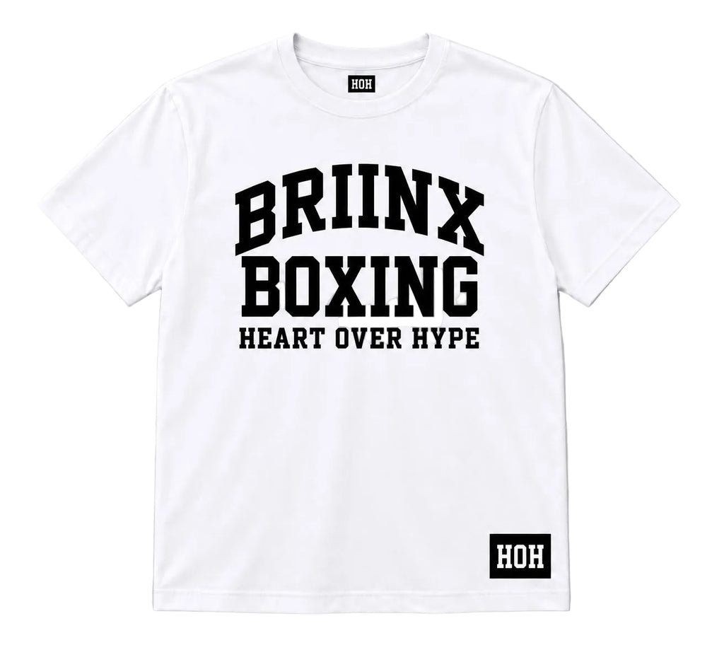 A white short-sleeve crewneck t-shirt with bold black text reading 'BRIINX BOXING' and 'HEART OVER HYPE' on the front, featuring a small black 'HOH' brand patch on the bottom right hem.