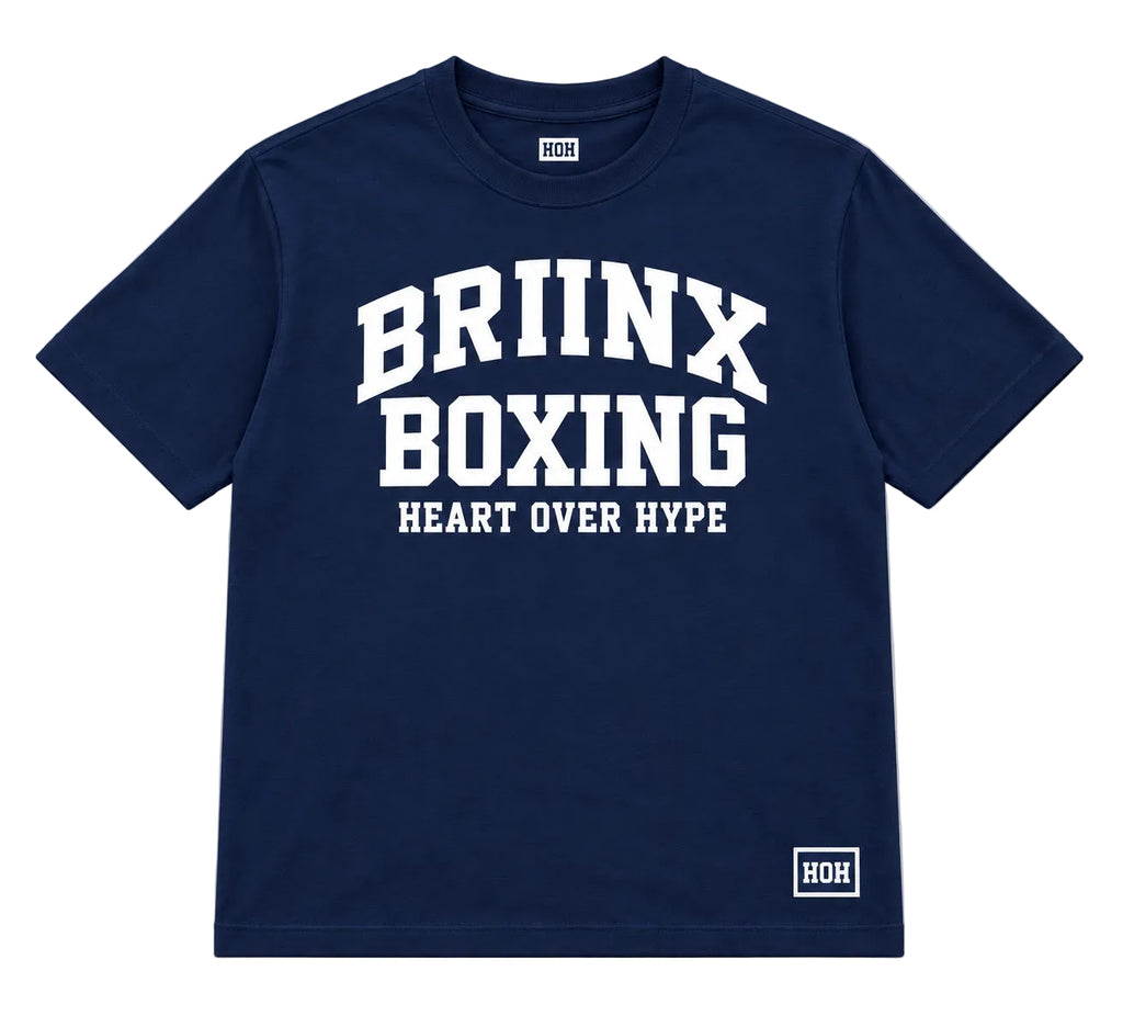 A navy blue short-sleeve t-shirt with 'BRIINX BOXING' and 'HEART OVER HYPE' printed in white on the front, featuring a small white ROH logo on the bottom right hem and inside the collar, shown on a neutral gray background.