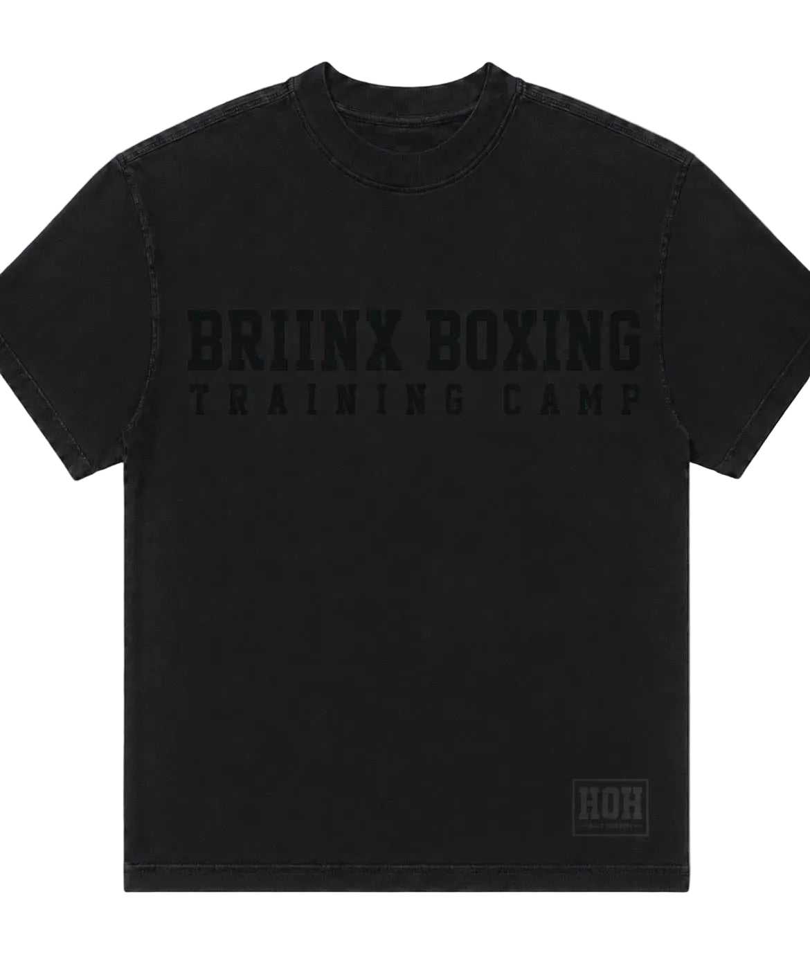 A black short-sleeve t-shirt with 'BRIINX BOXING TRAINING CAMP' printed in a tonal black font across the chest, and a small 'HOH' logo patch on the bottom right hem, shown against a neutral gray background.