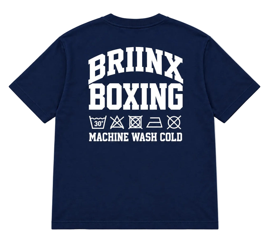 A navy blue short-sleeve t-shirt shown from the back, featuring a large white graphic print that reads 'BRIINX BOXING' with laundry care symbols and 'MACHINE WASH COLD' underneath, displayed on a neutral gray background.
