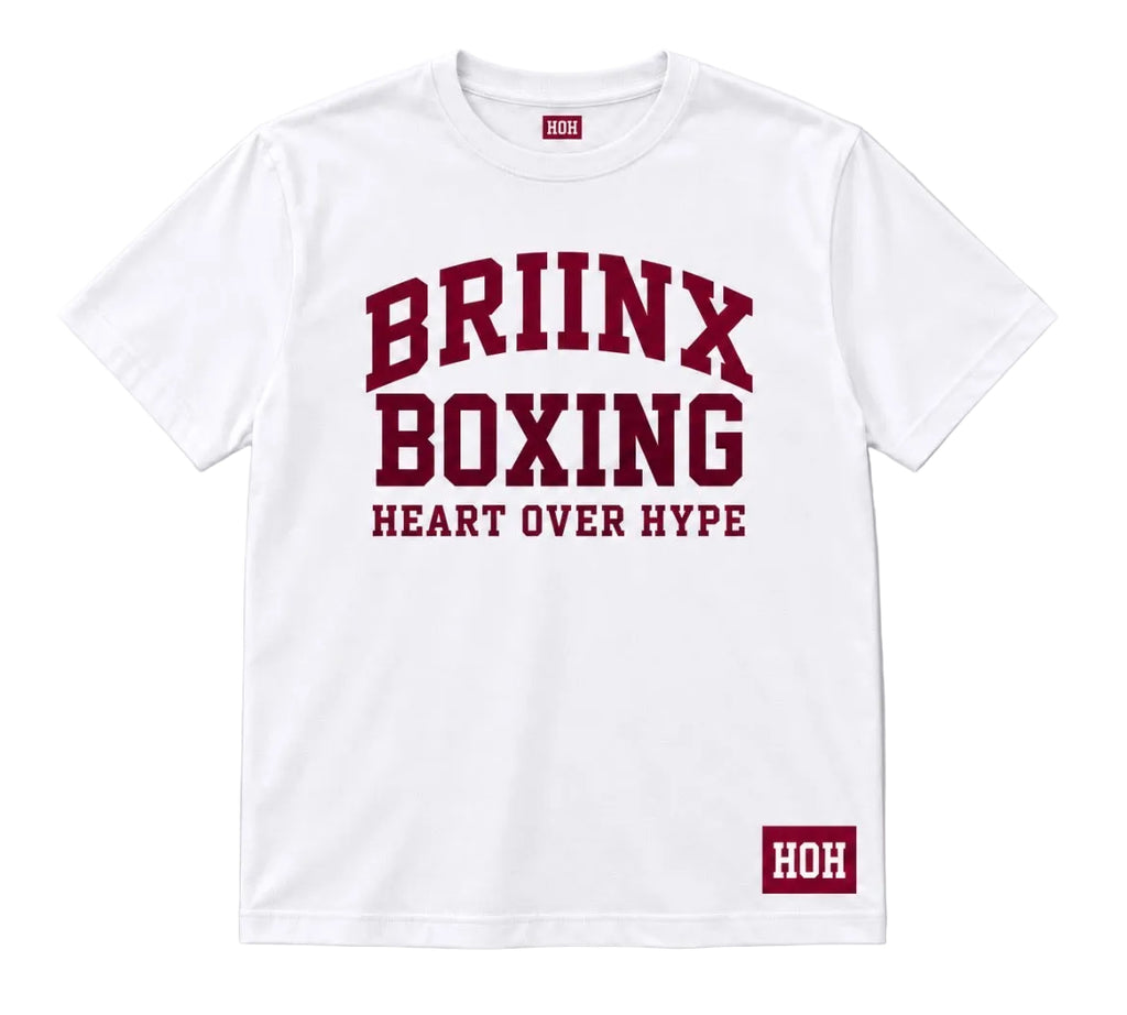 A white short-sleeve crewneck t-shirt with a maroon collegiate-style graphic on the front reading 'BRIINX BOXING HEART OVER HYPE', plus a small maroon 'HOH' label near the lower right hem, shown on a light gray background.