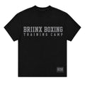 A black short-sleeve t-shirt with 'BRIINX BOXING TRAINING CAMP' printed in distressed gray letters across the chest, and a small 'HOH' logo patch on the bottom right hem, shown against a light gray background.